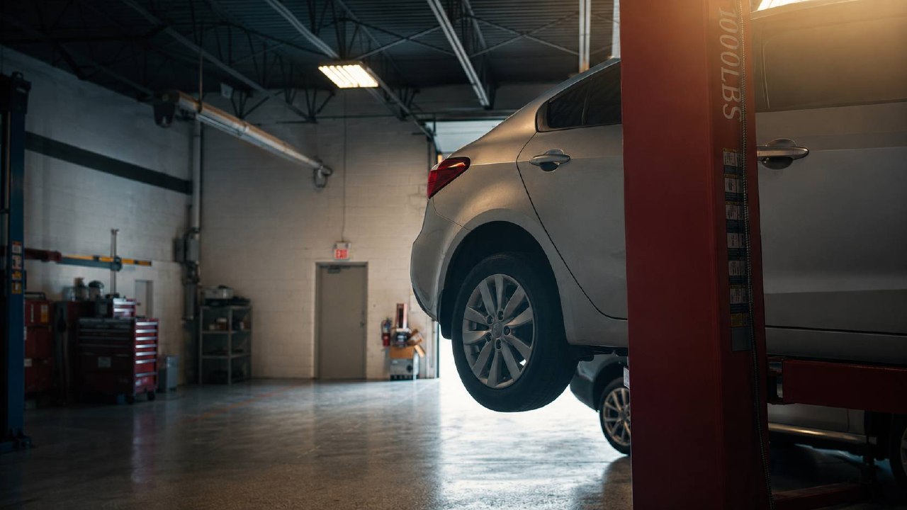 Vehicle raised in the bright K-Auto service bay